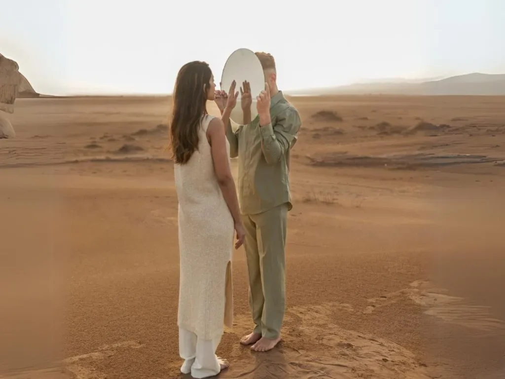 This shot captures the beautiful moment when a couple poses in front of a mirror, capturing their reflection.